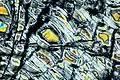 Gelber Olivin in serpentinisiertem Peridotit. Sichtfeld: 2 mm.